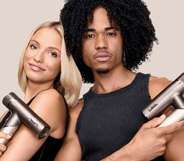 Two Glamsquad models holding the Shark Beauty SpeedStyle Pro Flex hair dryer for at-home blowouts